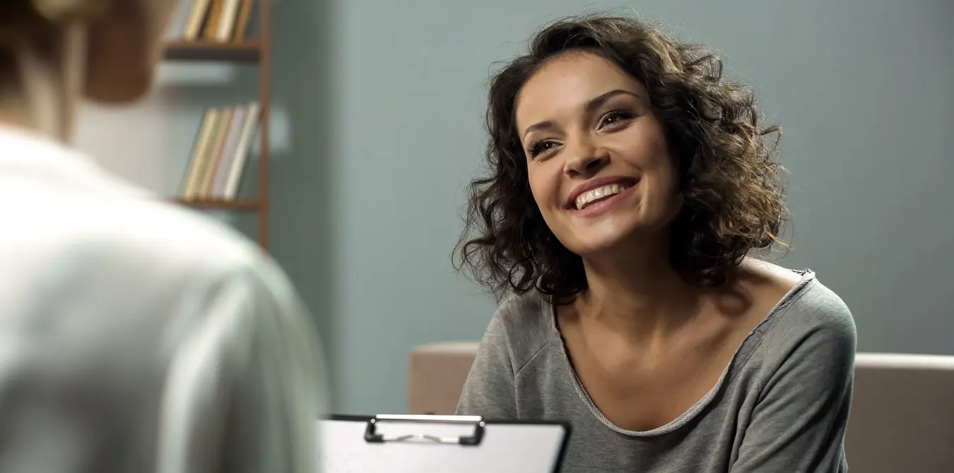 Happy woman receiving cognitive behavioral therapy